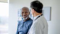 older black man in doctors office to doctor